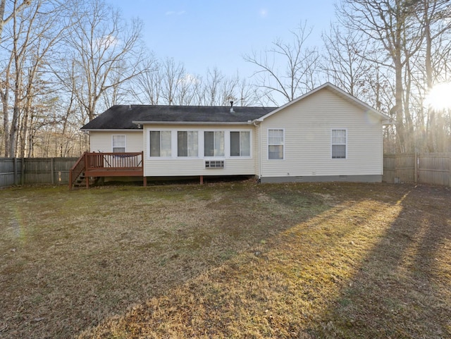 back of house featuring a yard and a deck