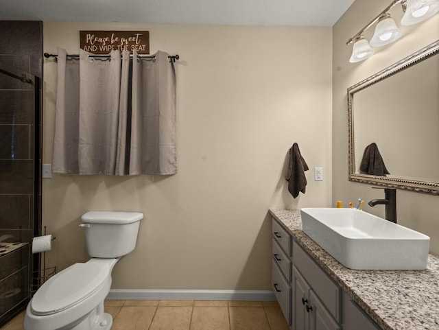 bathroom with vanity, tile patterned floors, toilet, and walk in shower