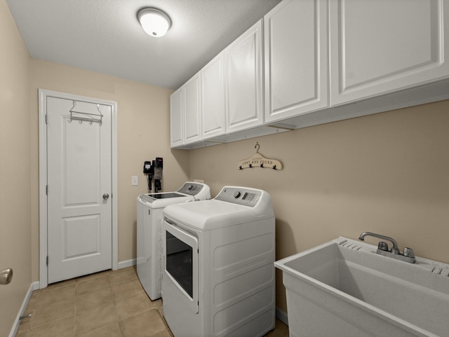 laundry room featuring independent washer and dryer, cabinets, light tile patterned flooring, and sink