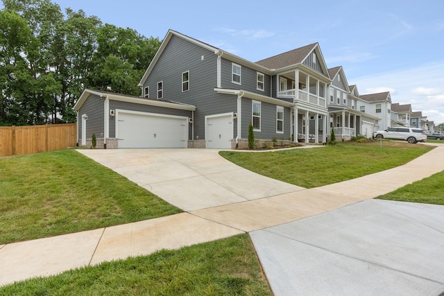 view of front of house with a garage, a front yard, and a balcony