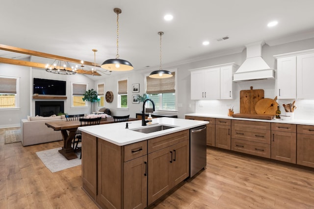 kitchen with sink, stainless steel dishwasher, custom range hood, white cabinets, and backsplash