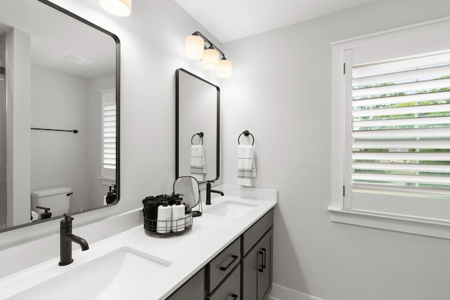 bathroom featuring vanity and toilet