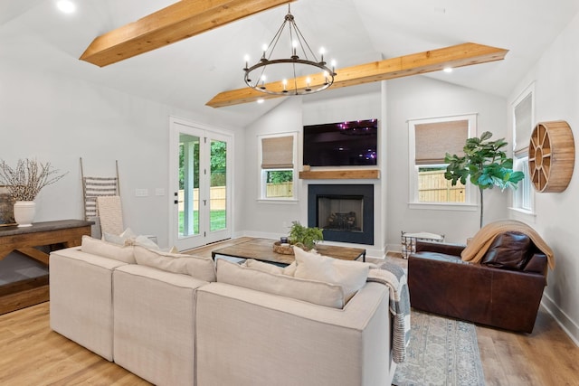 living room with vaulted ceiling with beams, an inviting chandelier, and light hardwood / wood-style floors