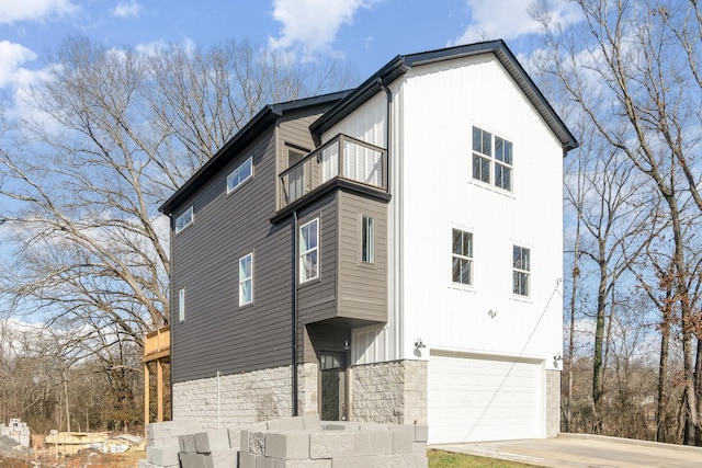 view of property exterior featuring a balcony and a garage