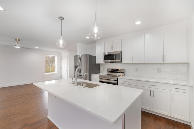 kitchen with white cabinetry, sink, an island with sink, and appliances with stainless steel finishes