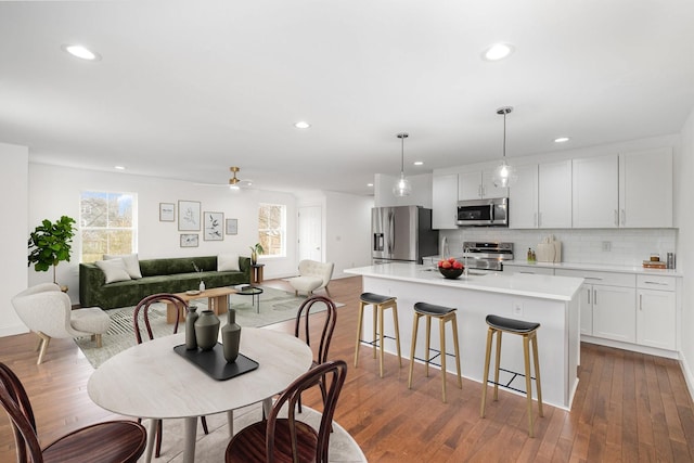 dining area featuring hardwood / wood-style flooring, a wealth of natural light, and ceiling fan