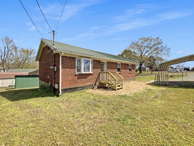 615 Lafayette Ct, Clarksville, TN 37042 - back of property featuring brick siding, metal roof, a carport, and a lawn