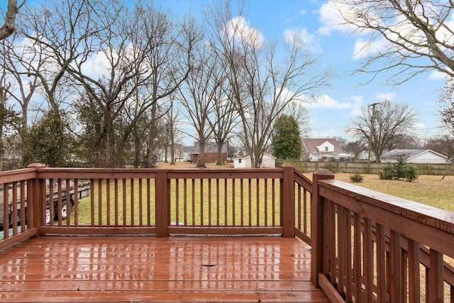 wooden deck featuring a yard