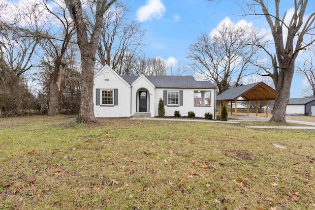 view of front of property with a front yard and a carport