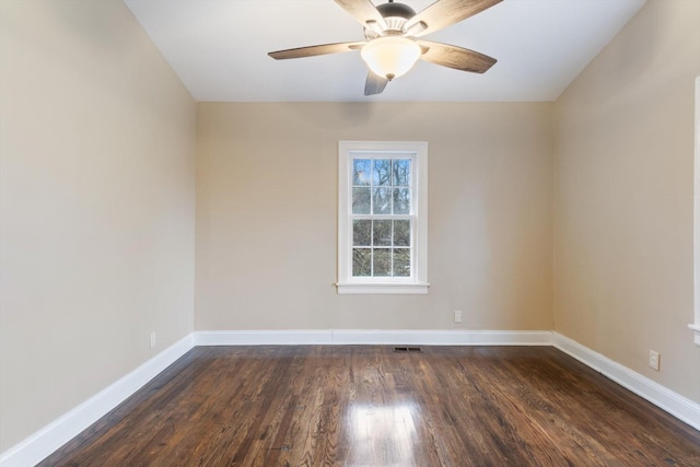 empty room with dark hardwood / wood-style floors and ceiling fan