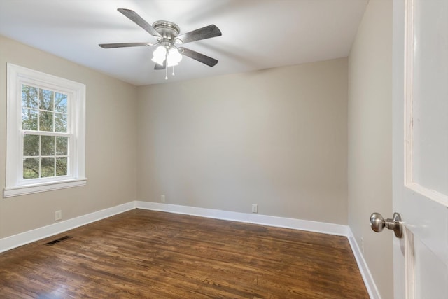 spare room with ceiling fan and dark hardwood / wood-style flooring