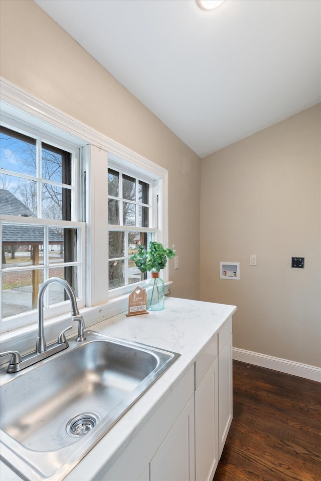 kitchen with a healthy amount of sunlight, sink, white cabinets, and dark hardwood / wood-style flooring