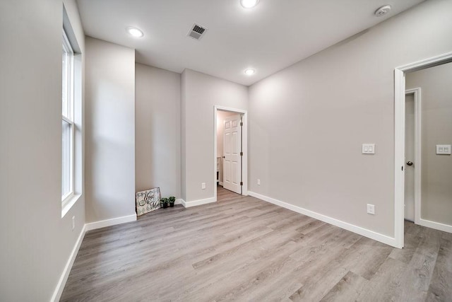 empty room with light hardwood / wood-style flooring