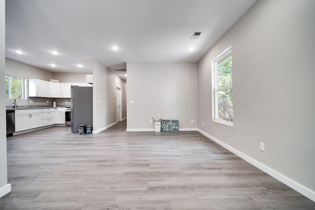 unfurnished living room featuring light hardwood / wood-style flooring