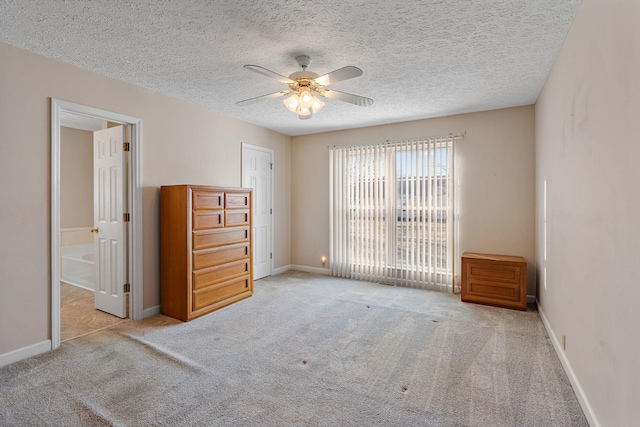 unfurnished room featuring ceiling fan, light carpet, and a textured ceiling