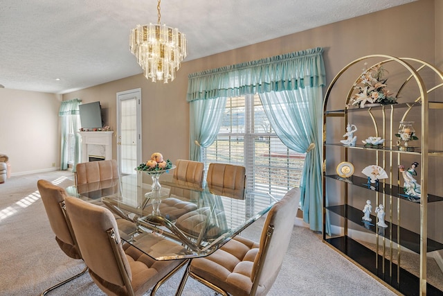 dining room with an inviting chandelier, light colored carpet, and a textured ceiling