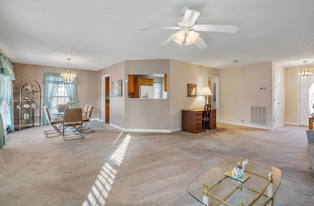 unfurnished living room with ceiling fan with notable chandelier, light colored carpet, and a textured ceiling