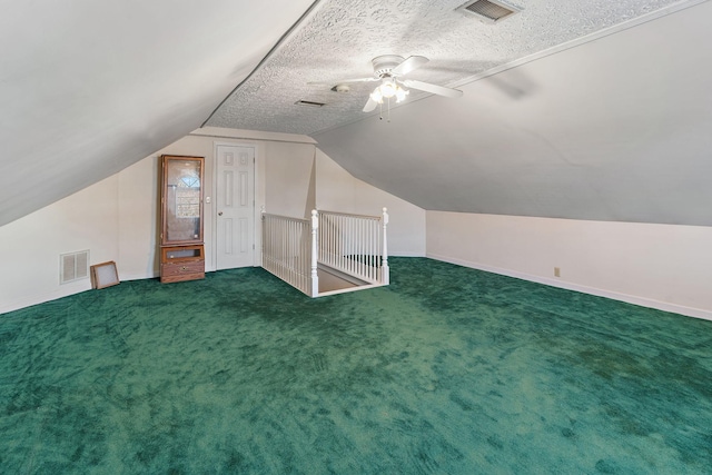 additional living space featuring ceiling fan, carpet, lofted ceiling, and a textured ceiling