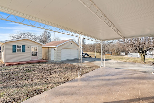 view of front of property with a carport, a garage, and an outdoor structure