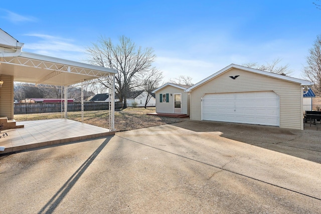 single story home featuring a garage and an outdoor structure