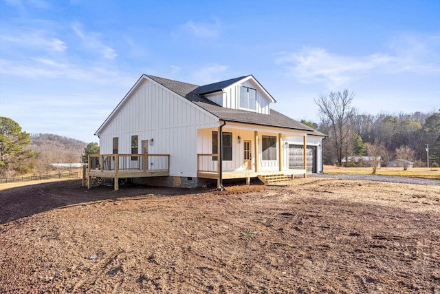 view of front of home featuring a garage and a wooden deck