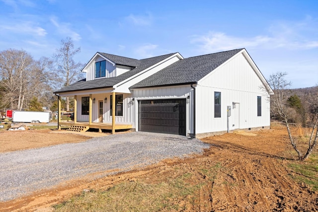 view of front of home with a garage and a porch