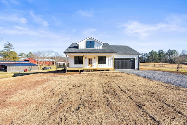 view of front of home featuring a garage and a porch