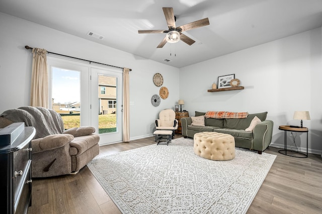 living room with ceiling fan and light hardwood / wood-style floors