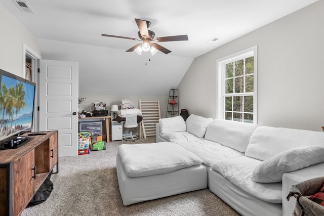 living room with ceiling fan, lofted ceiling, and light carpet