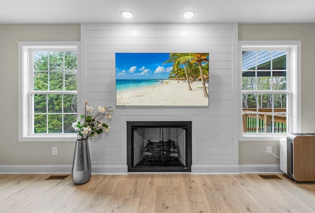 room details featuring hardwood / wood-style flooring and a large fireplace