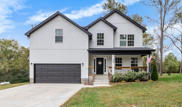 view of front of home featuring a garage, covered porch, and a front lawn