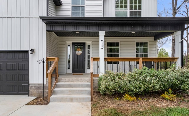 property entrance featuring a garage and a porch