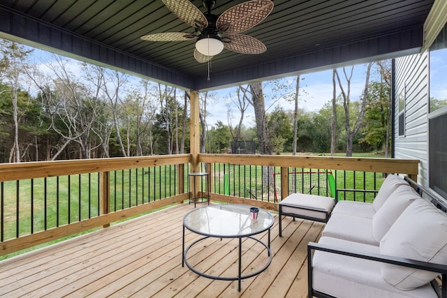 deck with a yard, outdoor lounge area, and ceiling fan