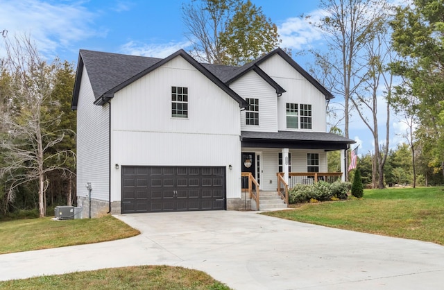 view of front of property featuring central AC unit, a garage, a front yard, and covered porch