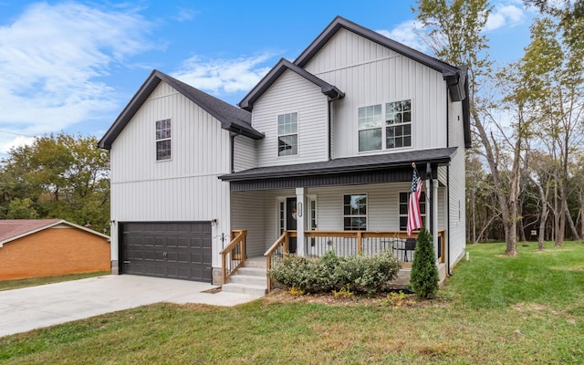 view of front facade with a garage, a front yard, and covered porch