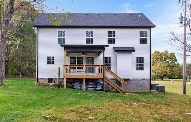 rear view of house with a lawn, ceiling fan, and a deck