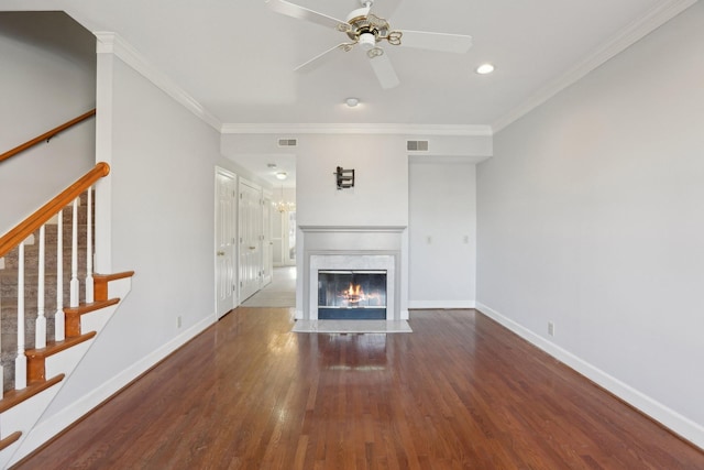 unfurnished living room with crown molding, ceiling fan, a high end fireplace, and dark hardwood / wood-style flooring