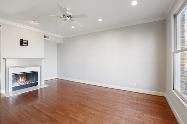 unfurnished living room with crown molding, hardwood / wood-style floors, ceiling fan, and a high end fireplace