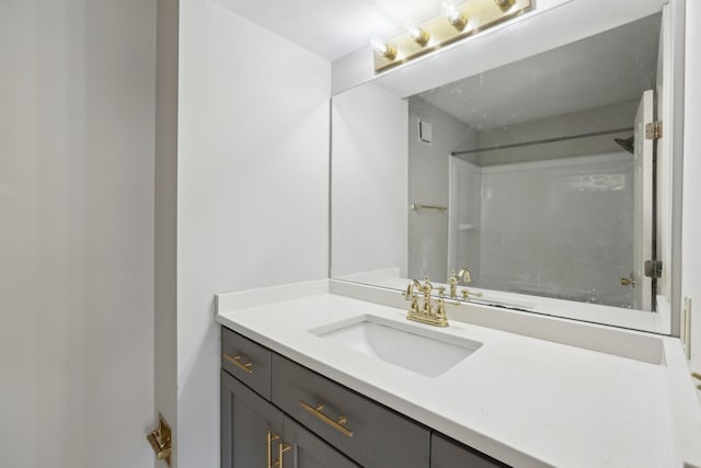 bathroom featuring vanity and a shower