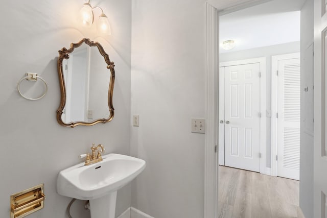 bathroom with wood-type flooring and sink