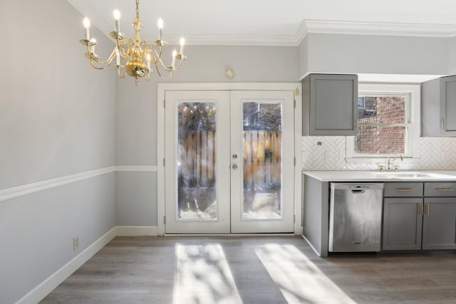 kitchen with french doors, stainless steel dishwasher, gray cabinets, and decorative backsplash