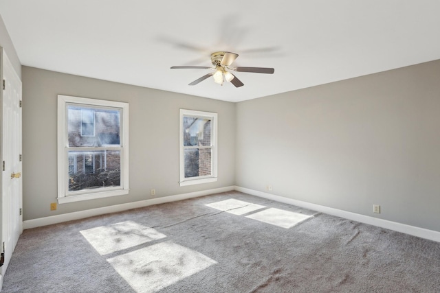 carpeted empty room featuring ceiling fan