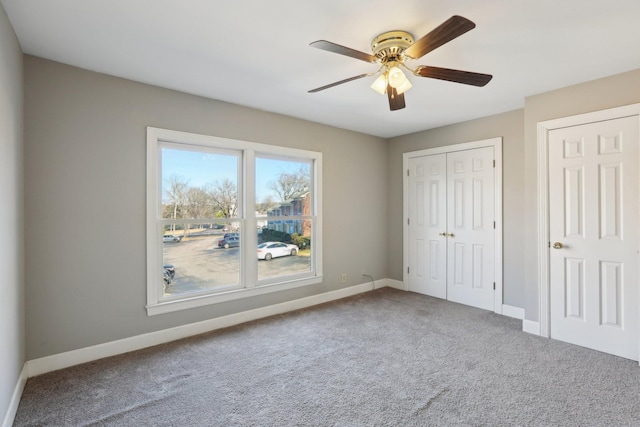 unfurnished bedroom featuring ceiling fan and carpet