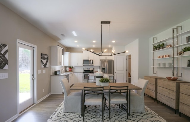 dining room featuring recessed lighting, visible vents, baseboards, and wood finished floors