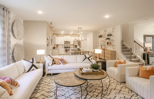 living room with stairs, a chandelier, and recessed lighting