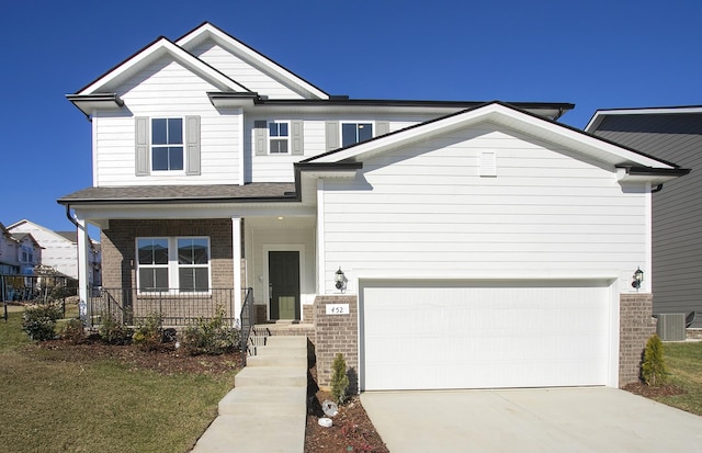 view of front facade featuring a porch, central air condition unit, a garage, brick siding, and concrete driveway