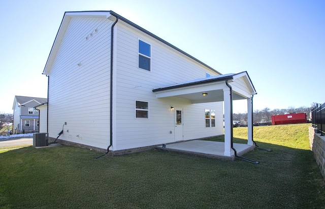 back of house featuring a yard, central AC, a patio area, and fence