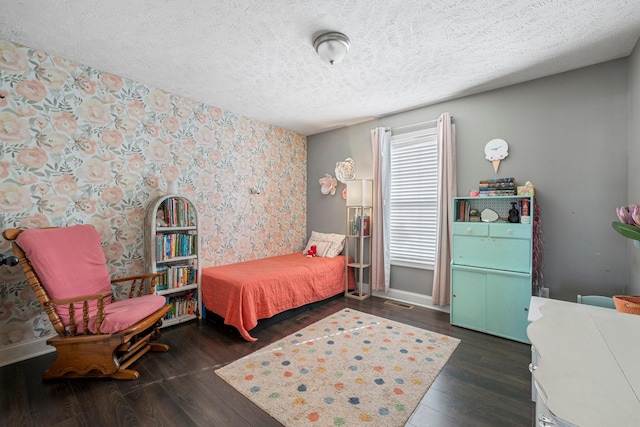 bedroom with dark hardwood / wood-style flooring and a textured ceiling