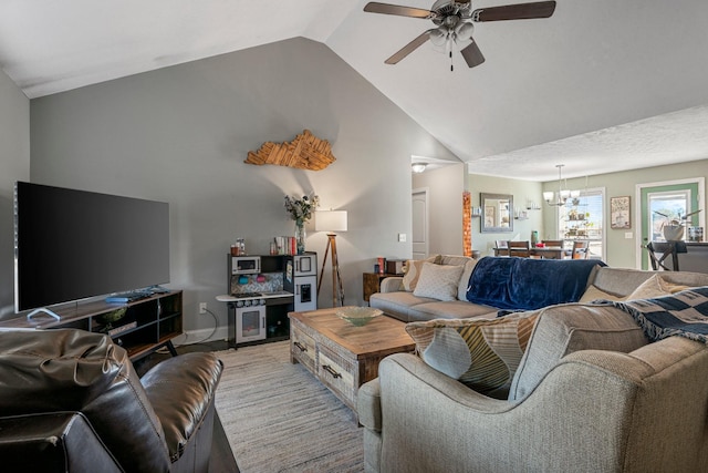 living room featuring ceiling fan and vaulted ceiling