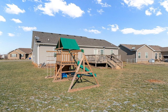 view of play area featuring a deck and a lawn